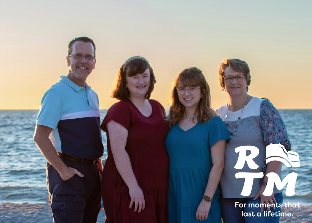 family photo on beach at sunset